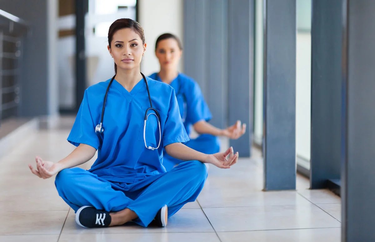 young healthcare workers meditation during break