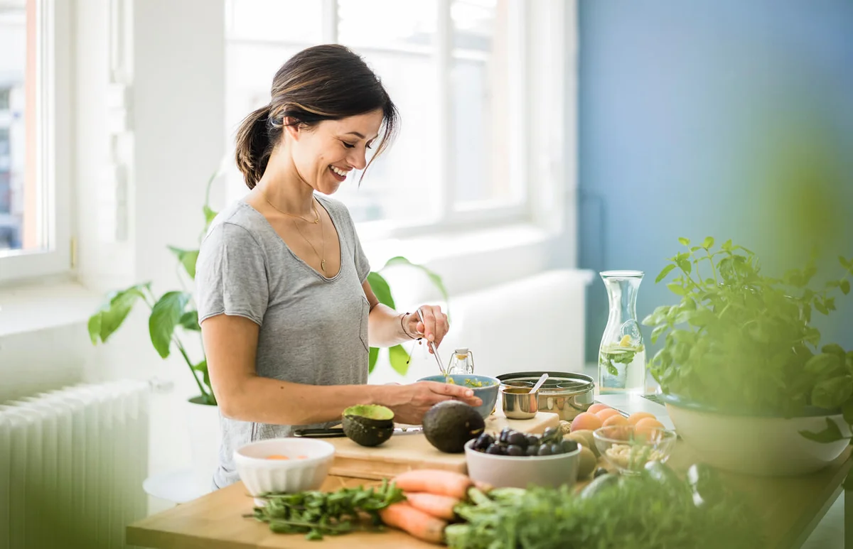 Woman preparing healthy food in her kitchen
