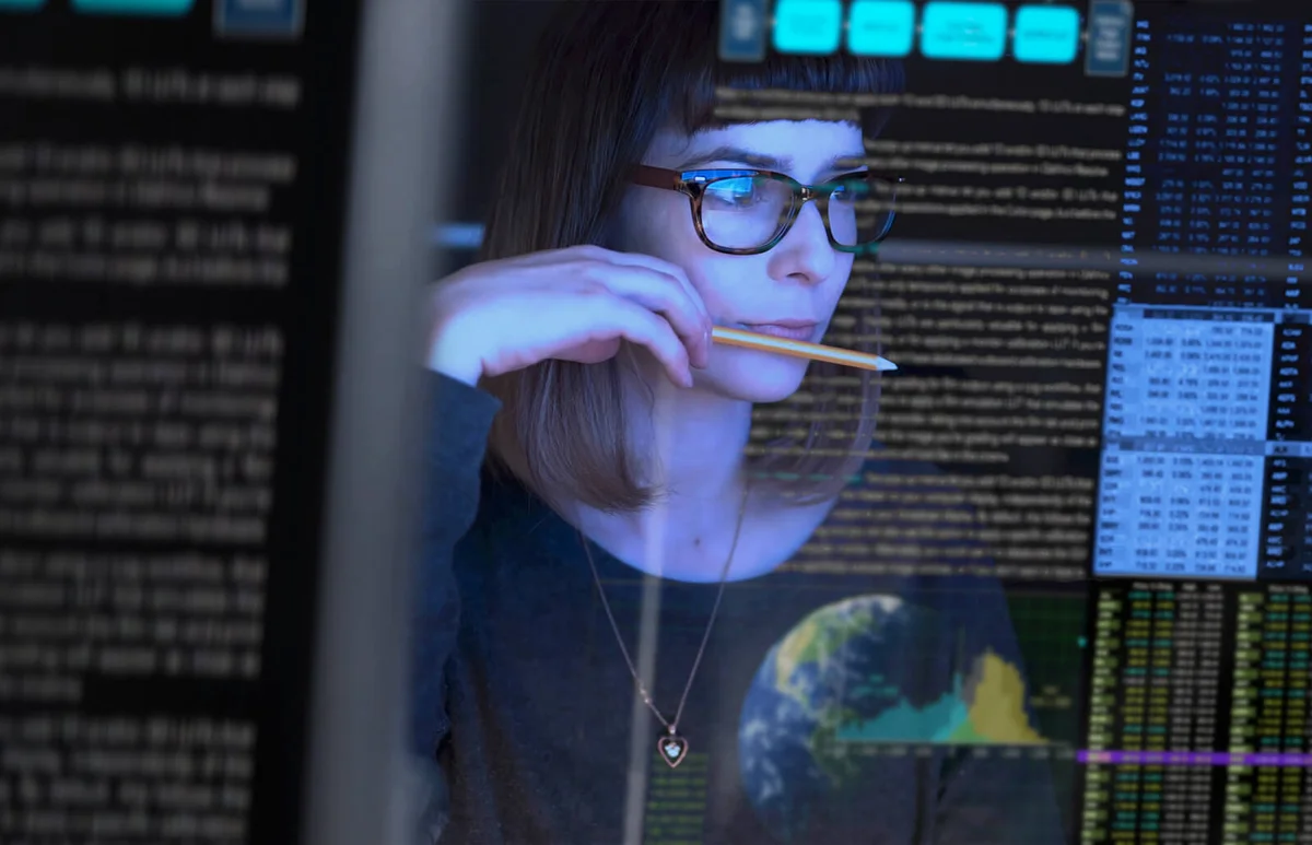 young woman studying a see through computer screen