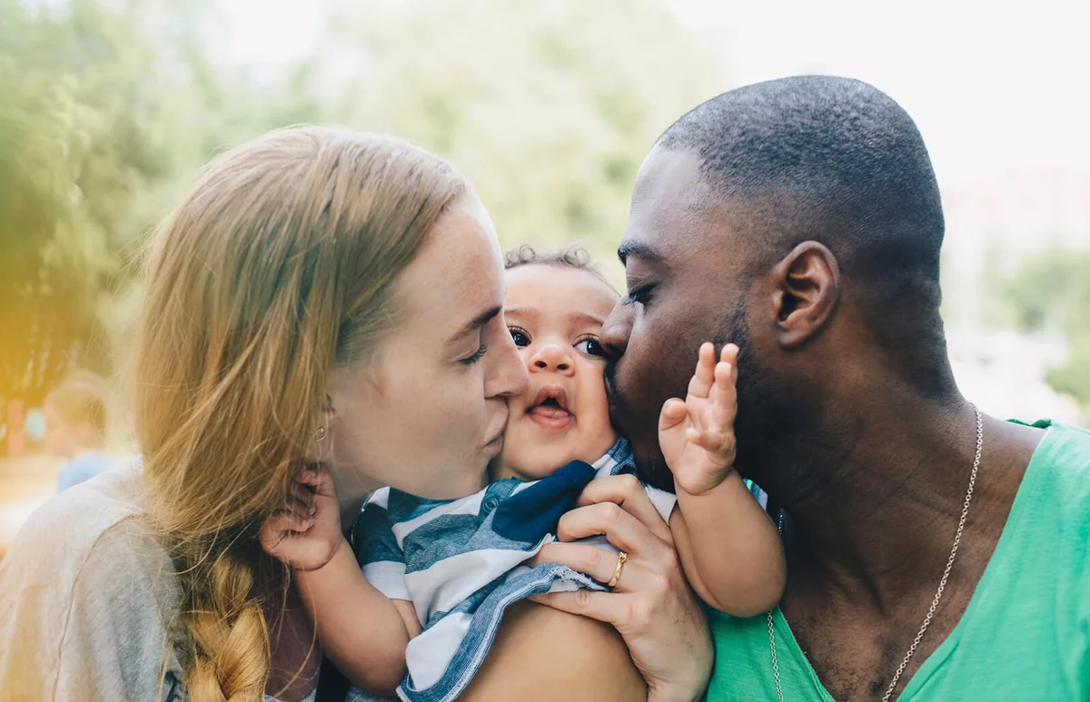 parents kissing son