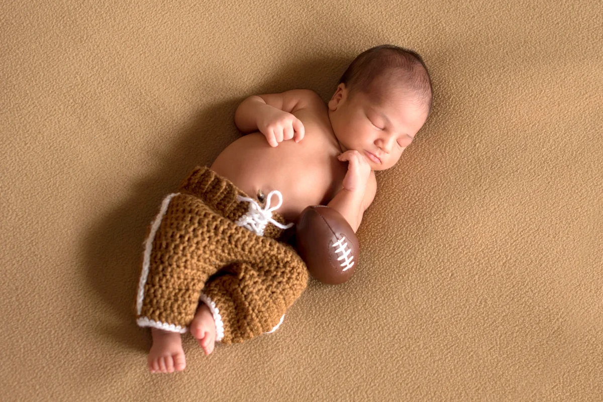 Newborn Baby Boy Wearing Football Uniform