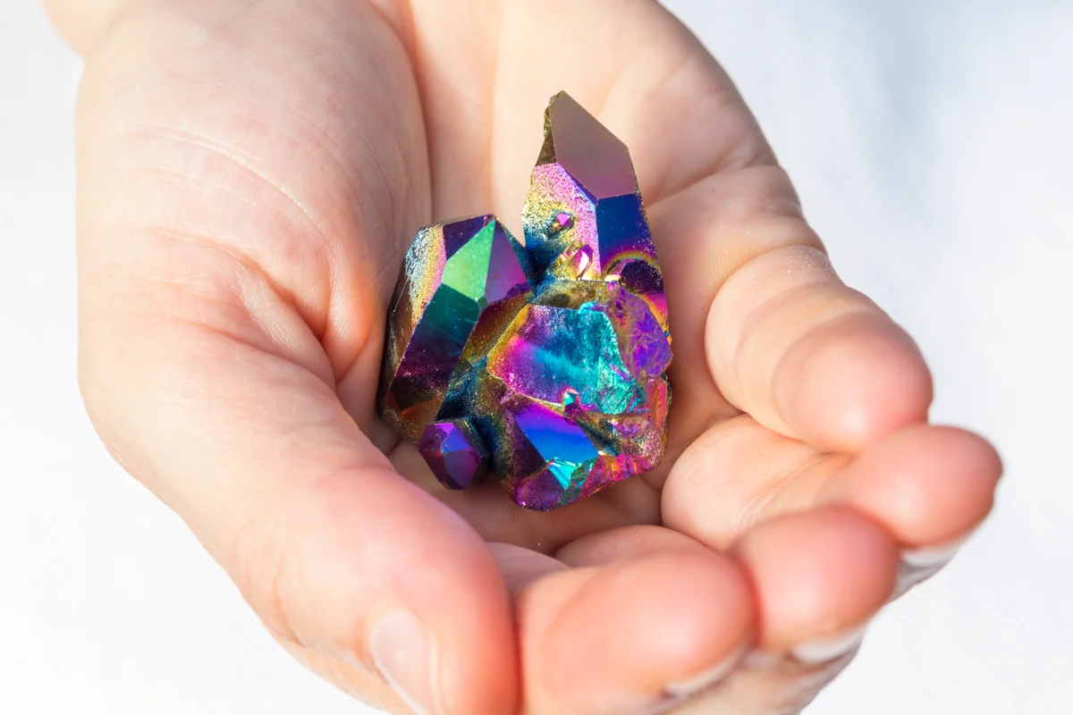 Piece of Rainbow Titanium Aura Crystal in hands