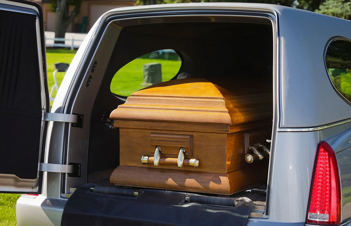 casket in the back of an open hearse