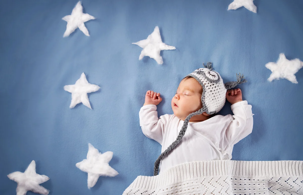 Cute newborn baby girl lying in the bed