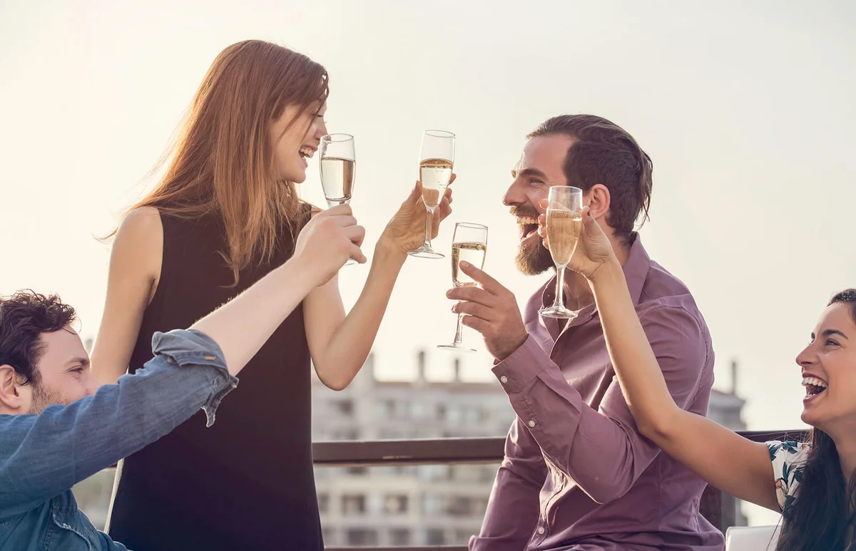 Group of friends relaxing with wine outdoors