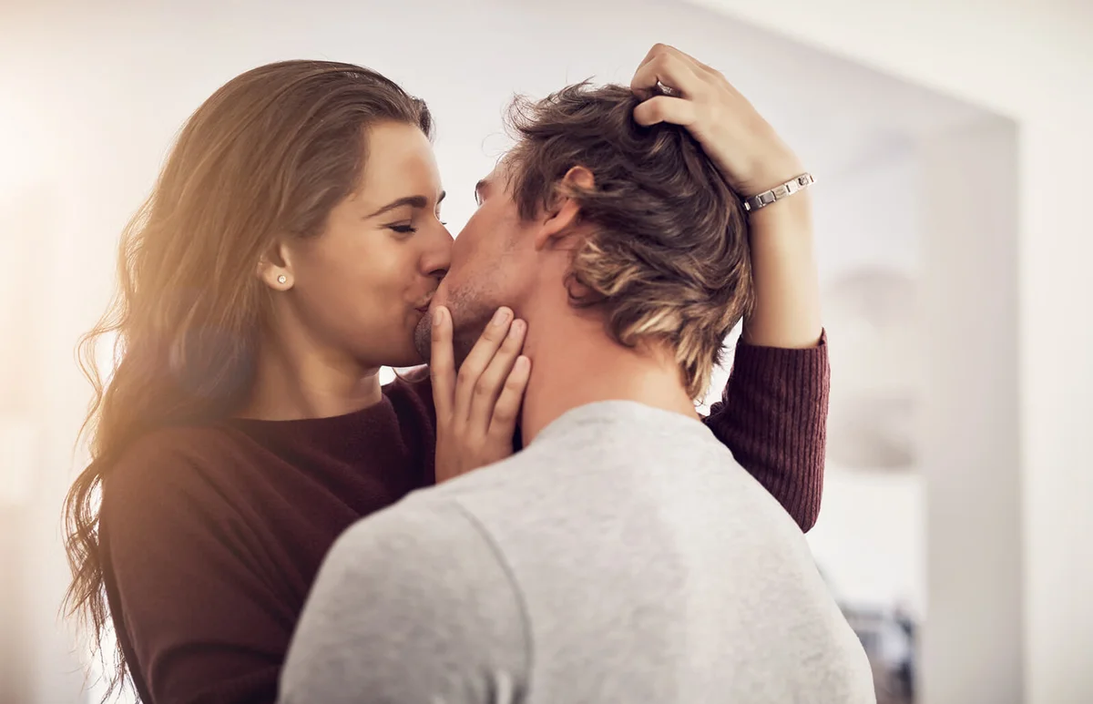 Shot of an affectionate young couple kissing in the kitchen at home