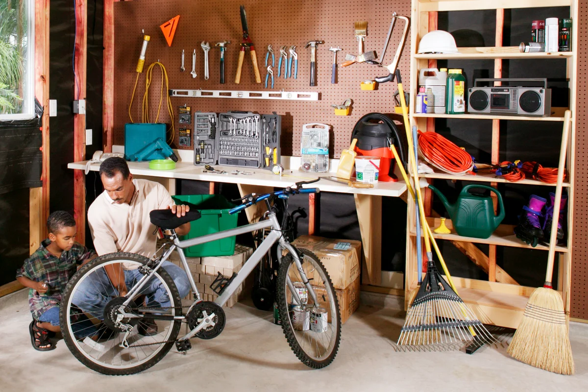 Father and Son Working on Bike Together in Garage