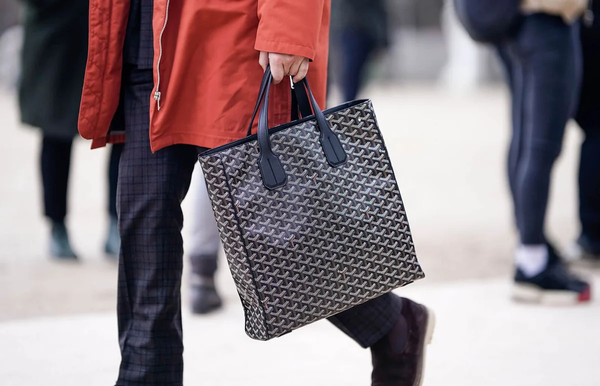 A Goyard bag is seen, outside Louis Vuitton, during Paris Fashion Week | Getty Editorial Use