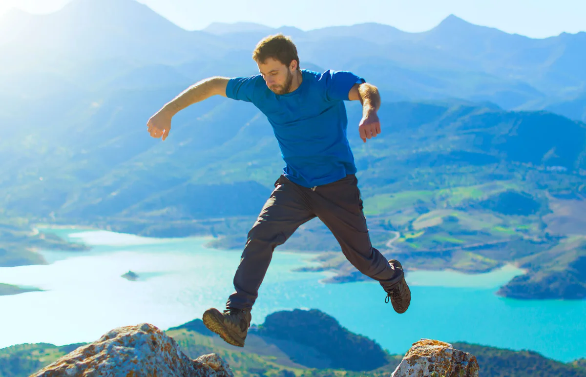 Young man jumping at the top of a mountain in Spain