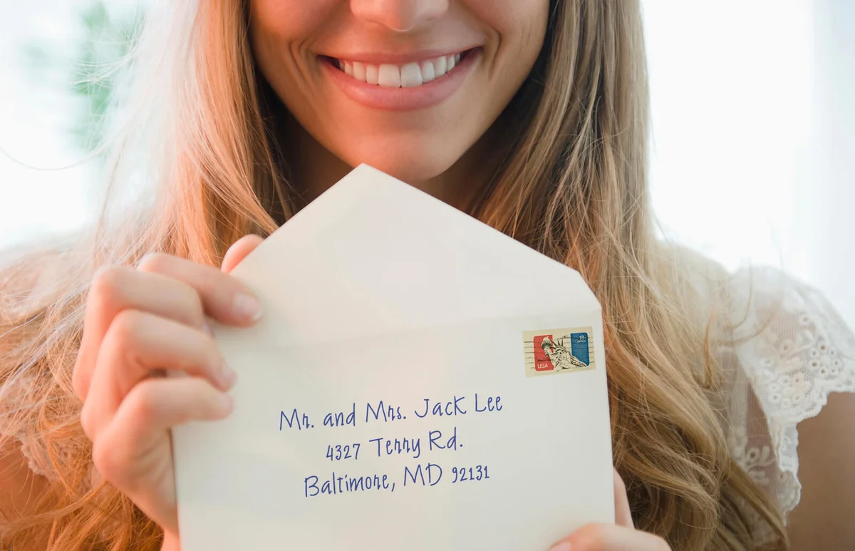 Portrait of woman holding envelope