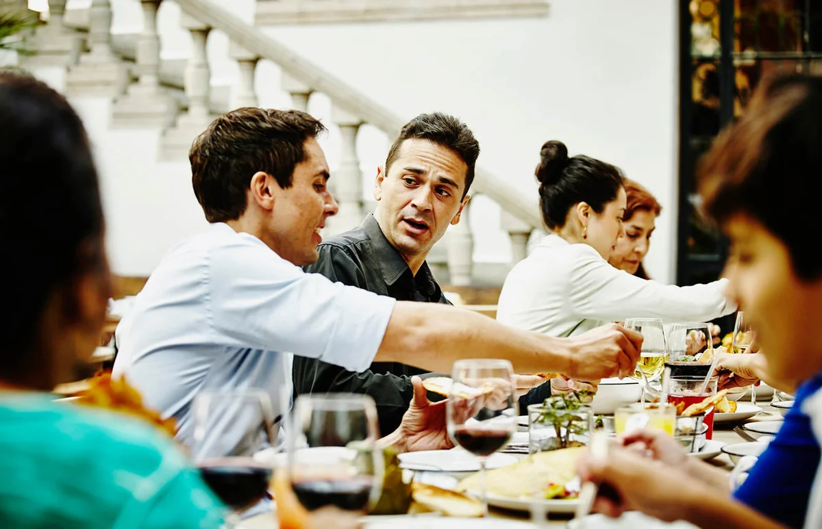 Brothers in discussion during family dinner party