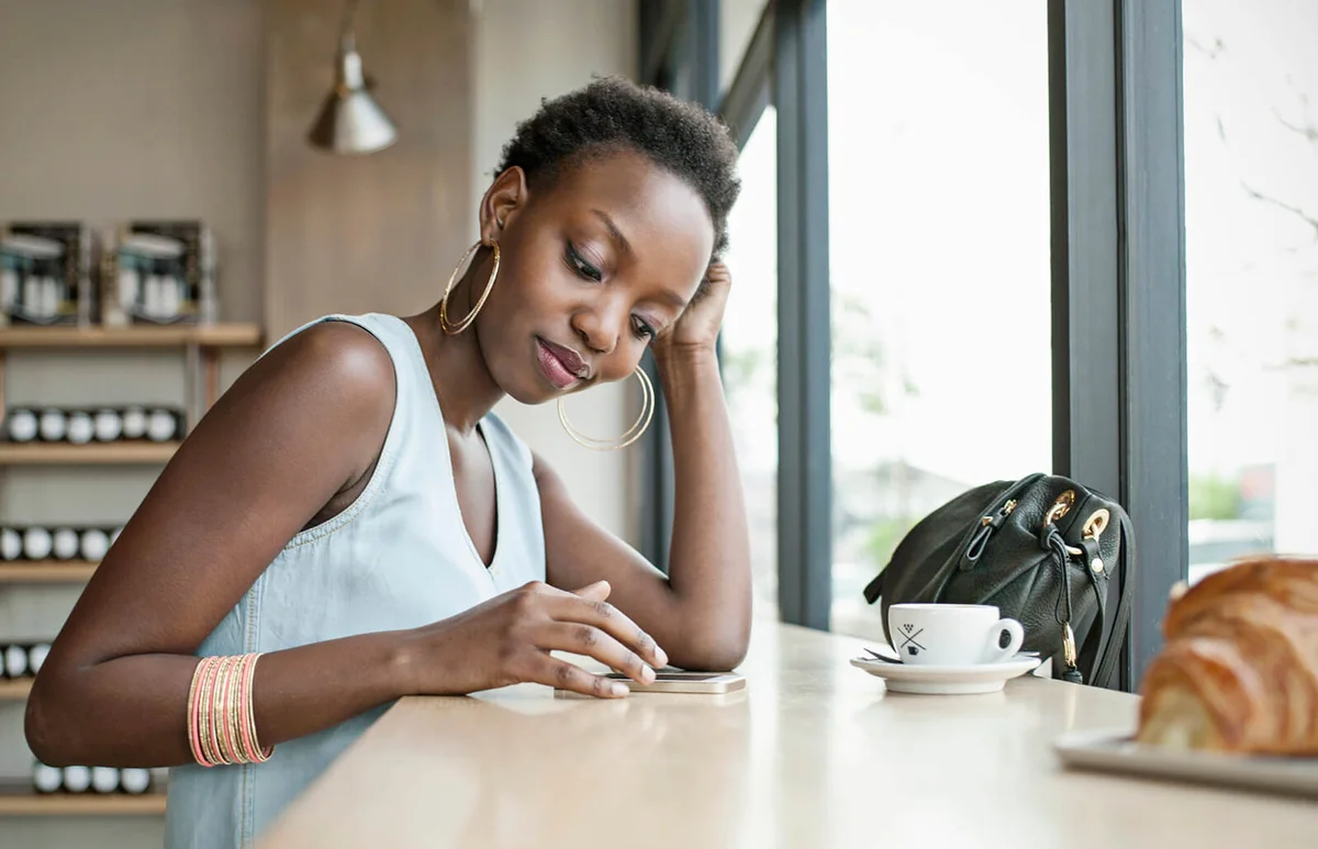 Young woman in café with mobile phone