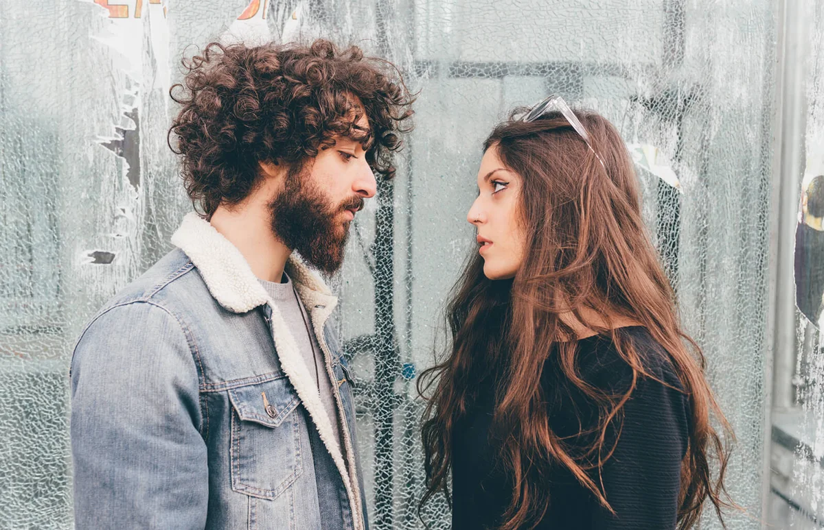 Young man and woman, standing face to face