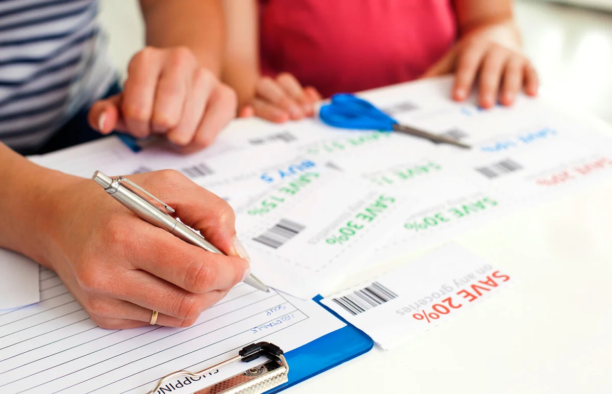 Family Making Shopping list and coupons.