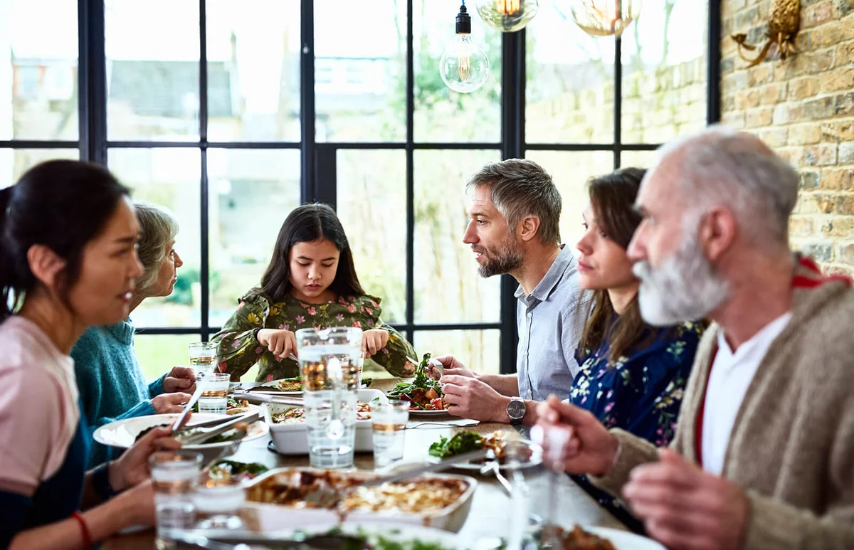 three generation family enjoying dinner together