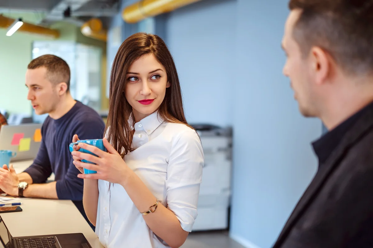 Girl looking at her colleague with love in her eyes