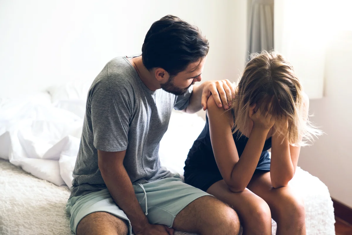 Husband comforts upset wife