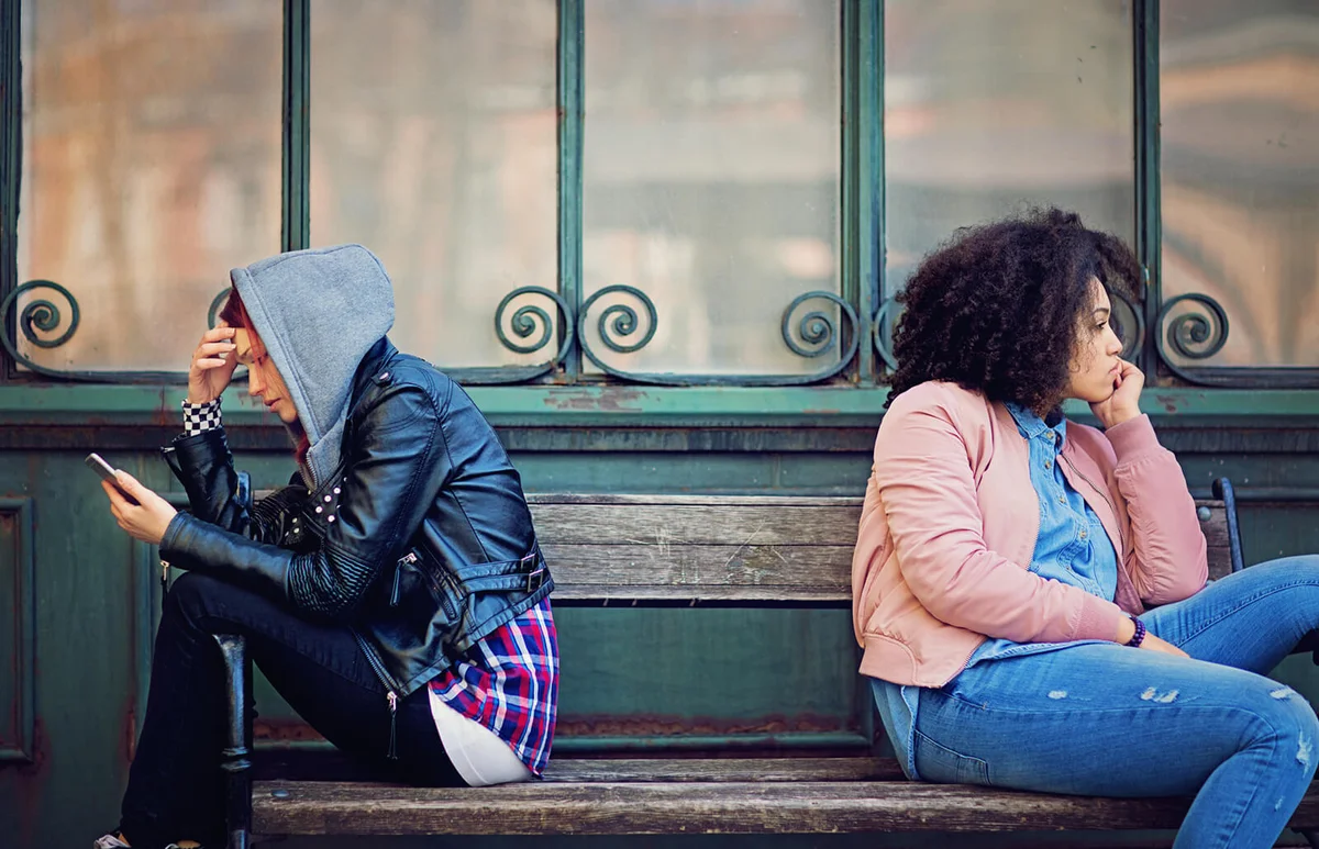 friends in conflict are sitting on the bench