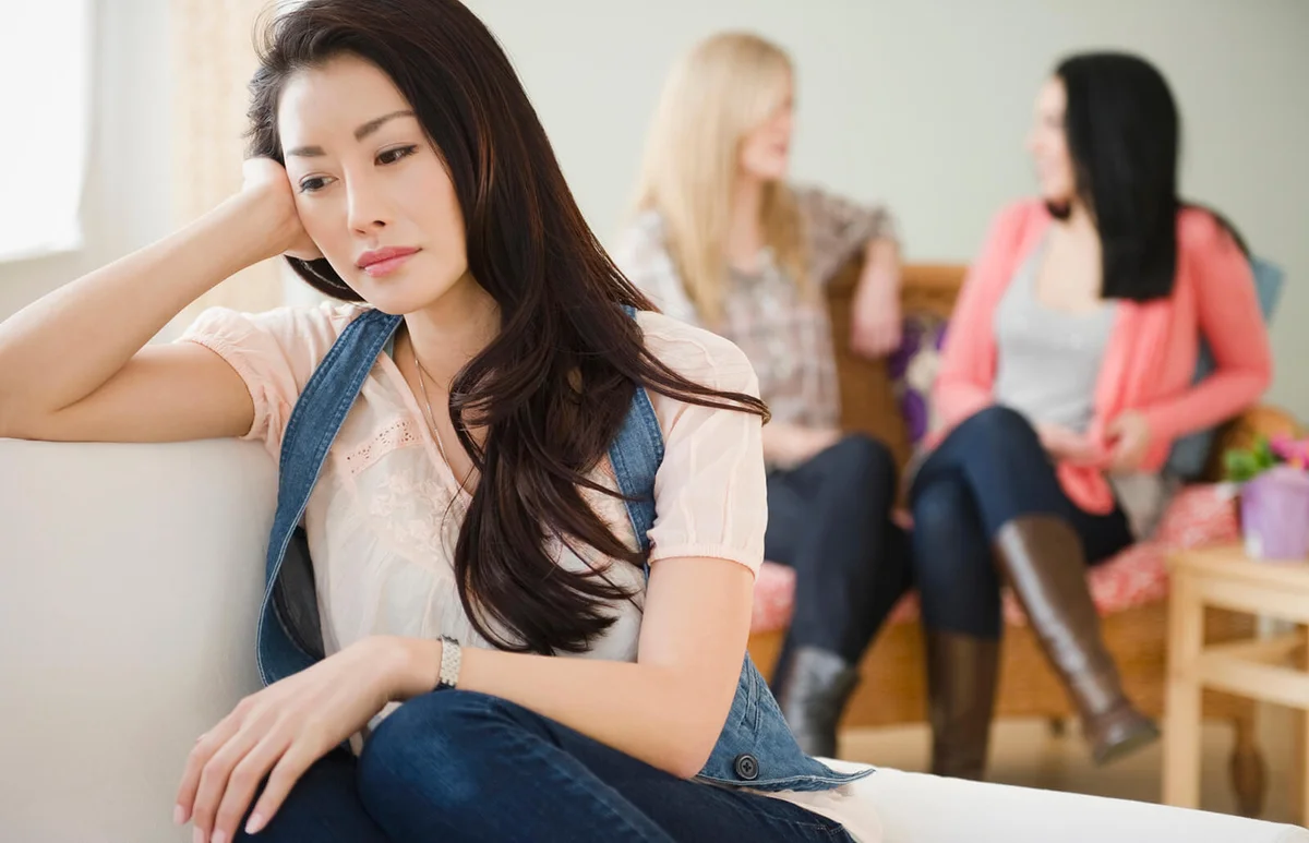 Sad woman isolated from friends