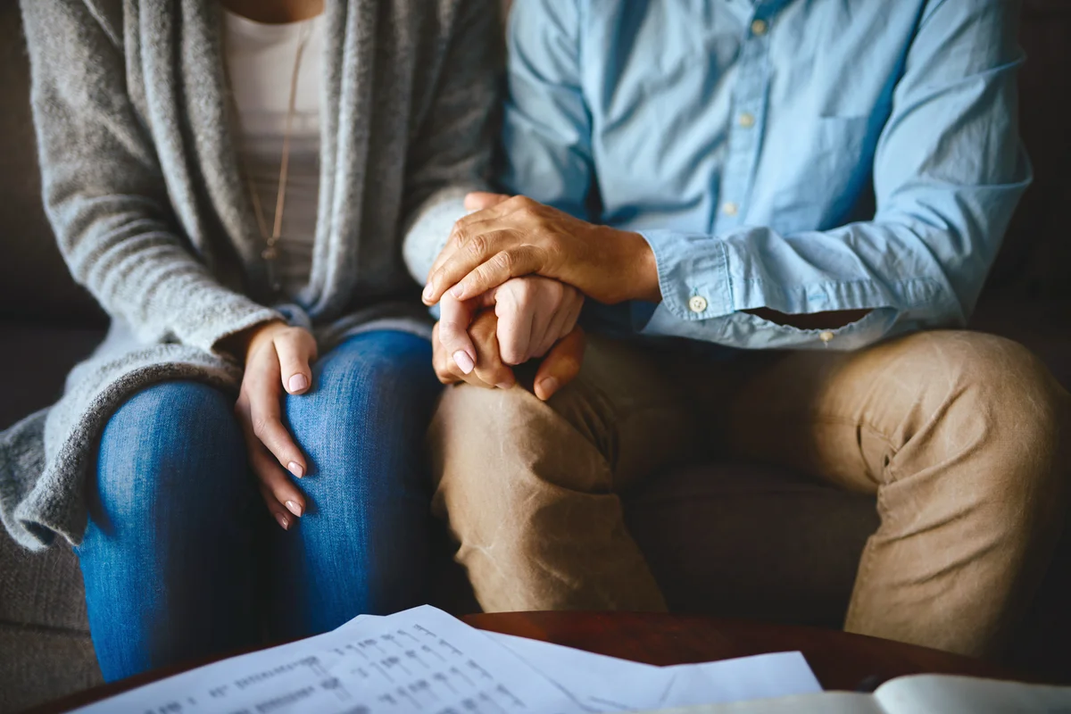 Couple holding hands in comfort