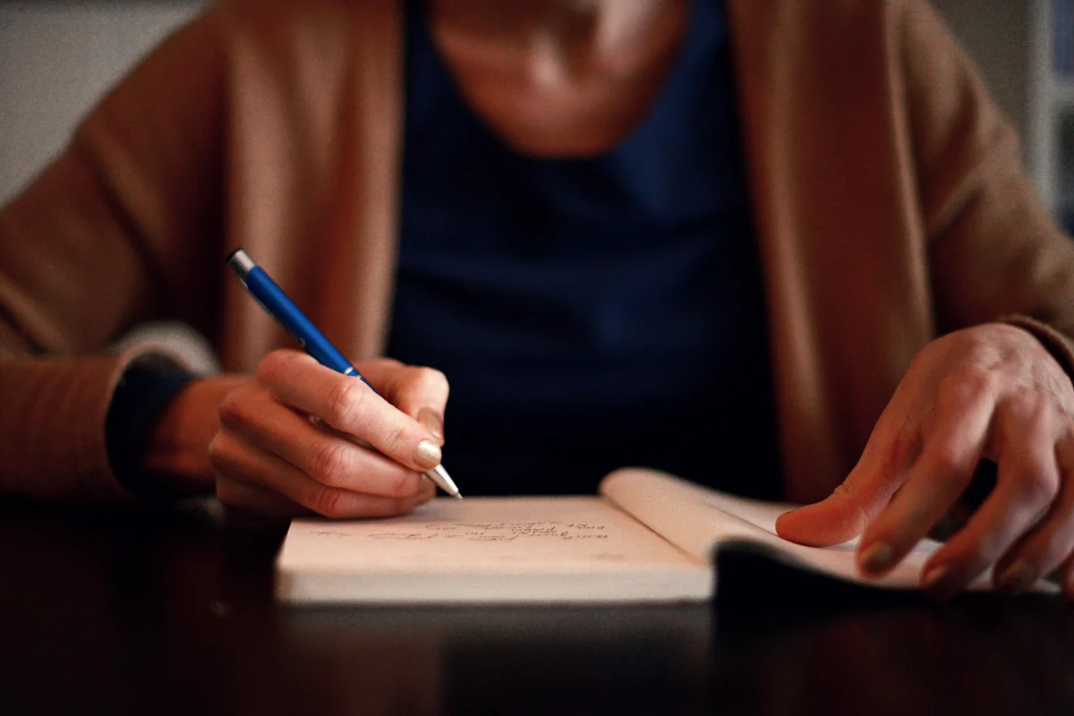 Woman writing in a notebook