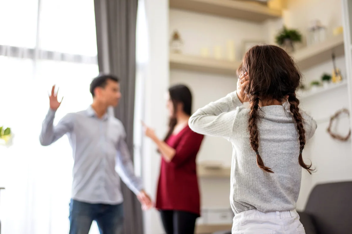 Daughter Looking At Parents Fighting In House