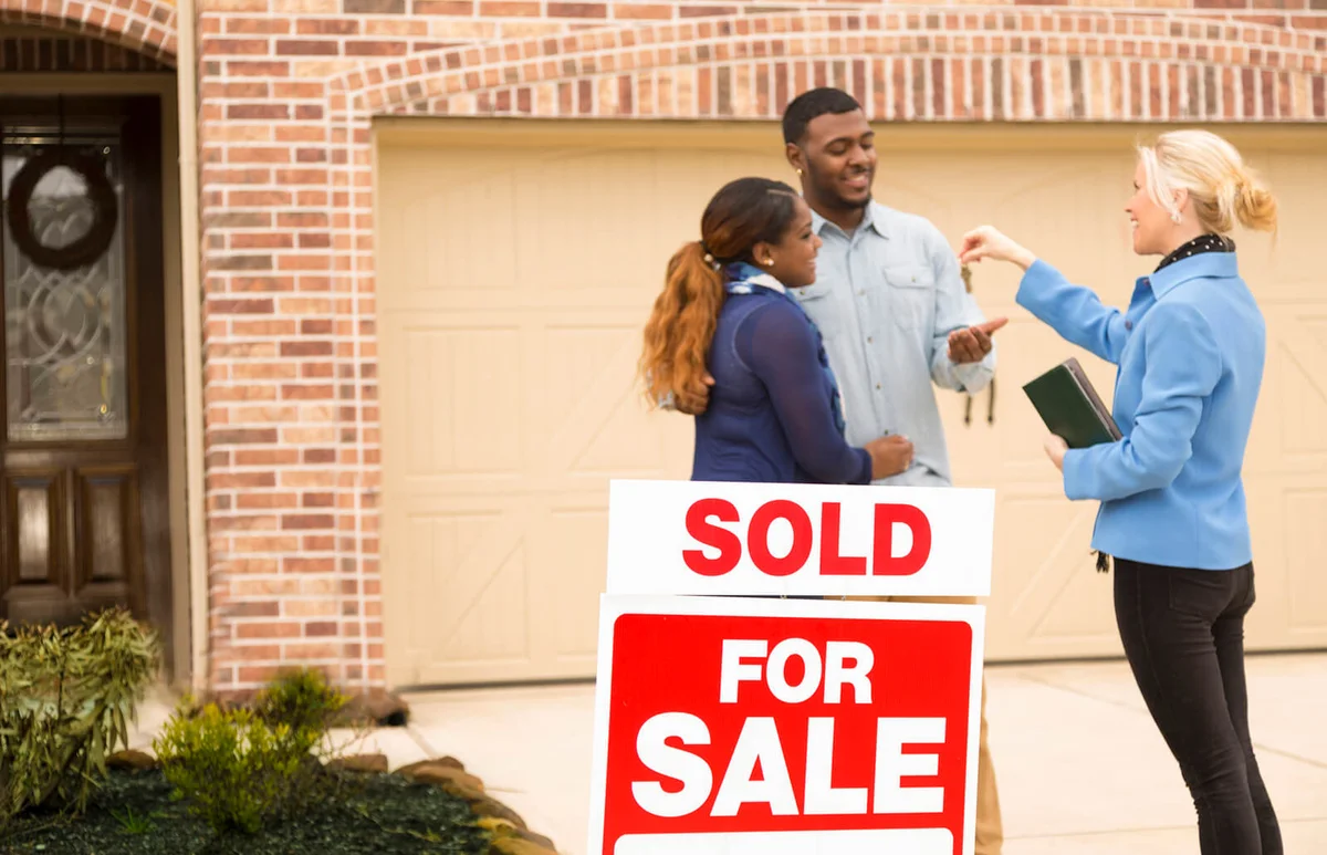 Couple receives keys to first home real estate purchase