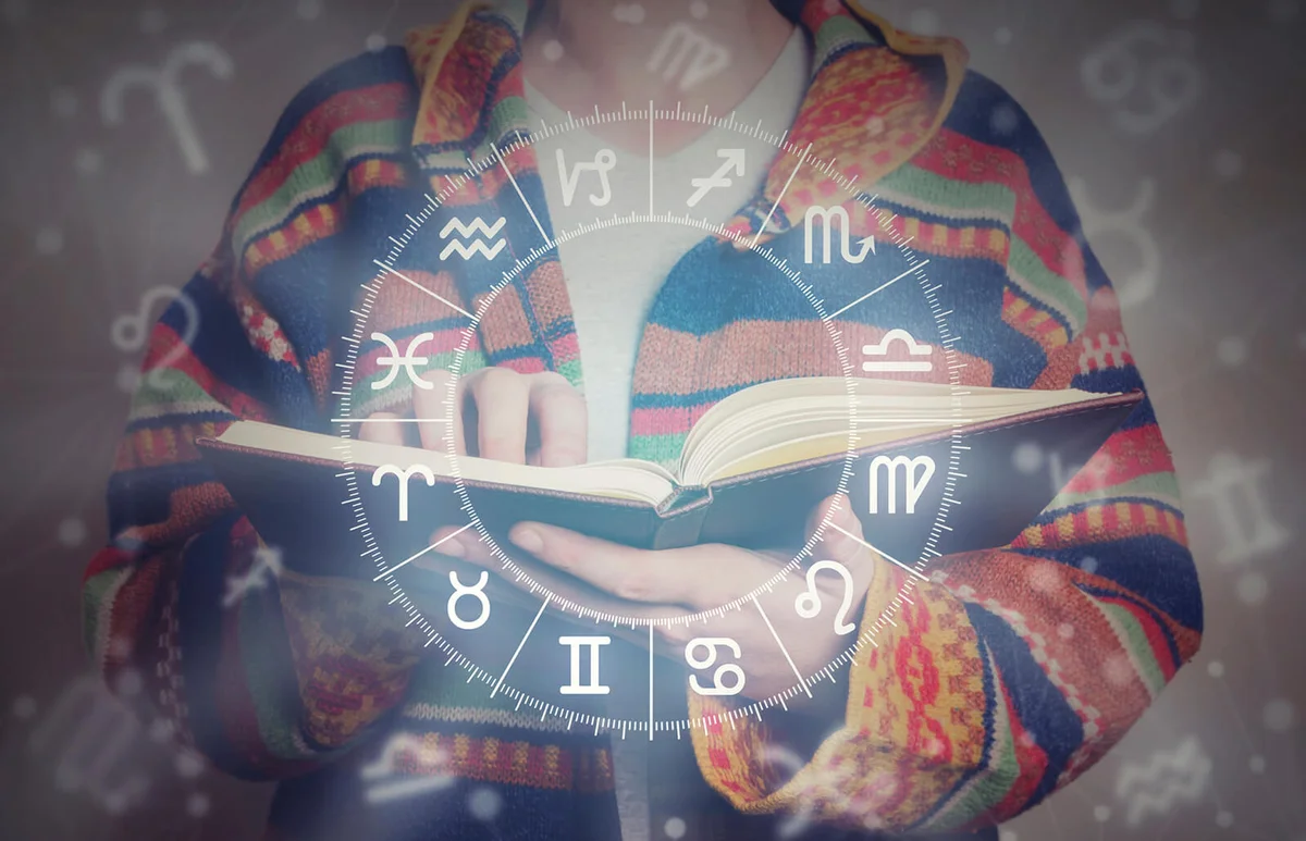 Young man reading an astrology book