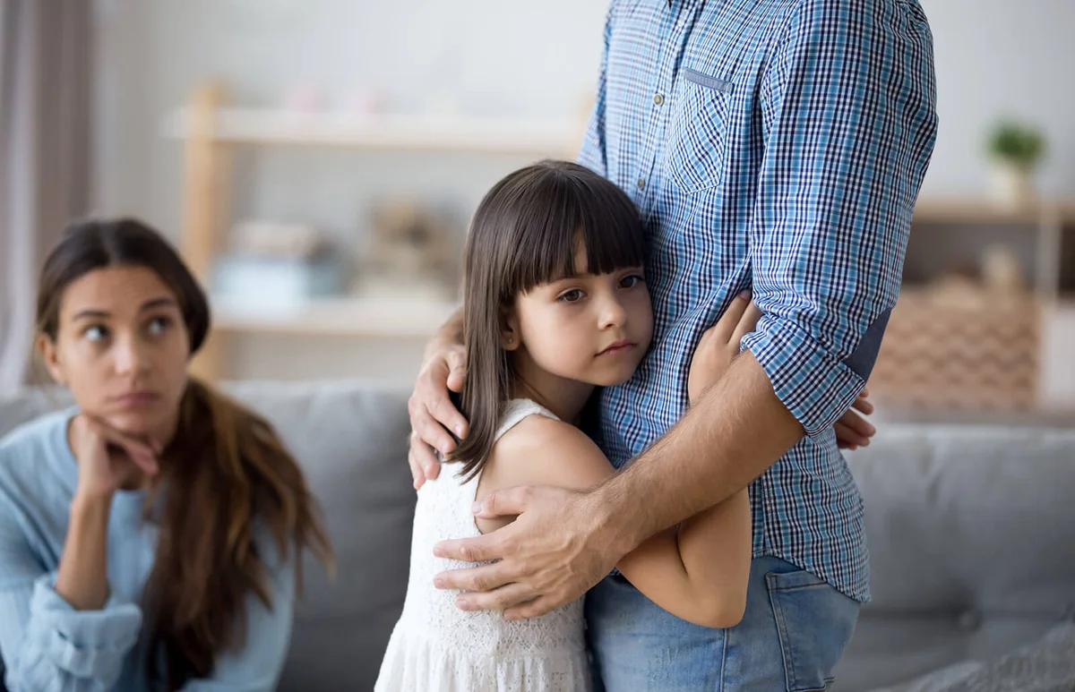 Sad little girl hug father