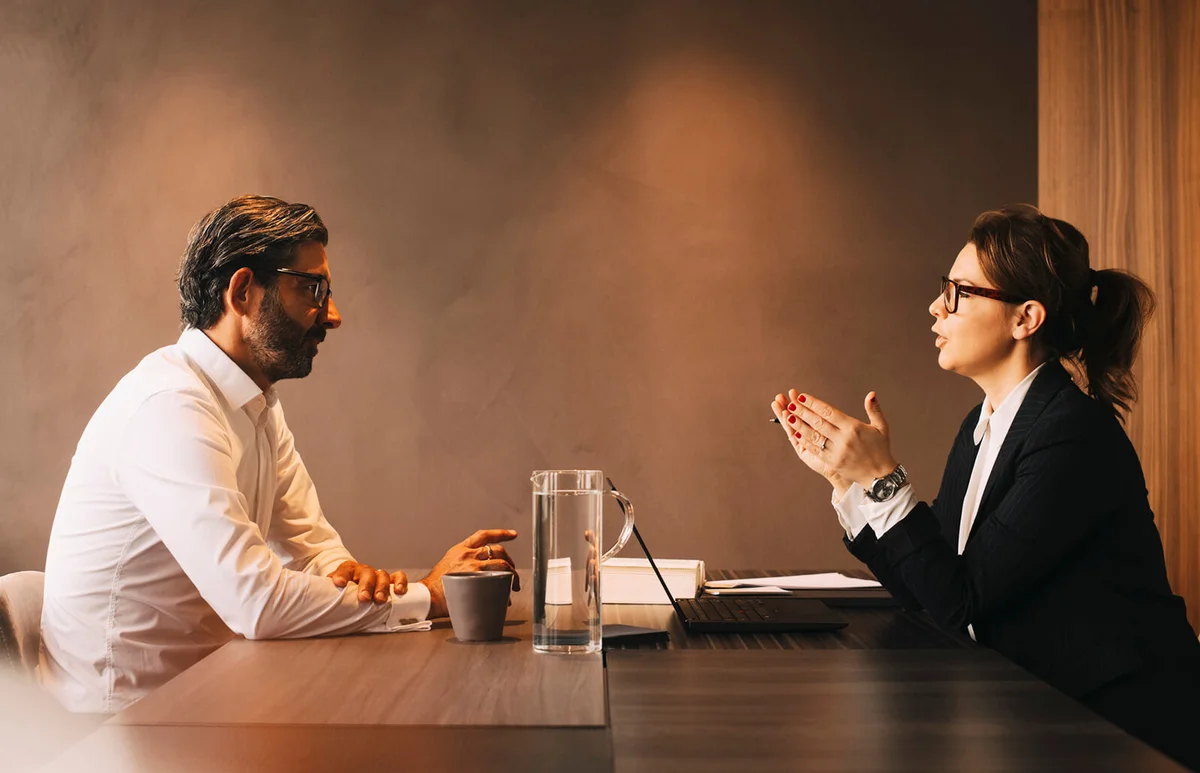 female lawyer explaining mature client in meeting at office