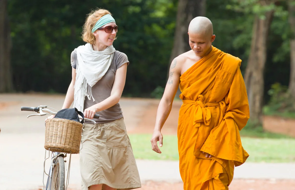 Tourist walking with local monk