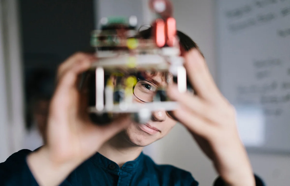 Teenager admiring homemade Robot