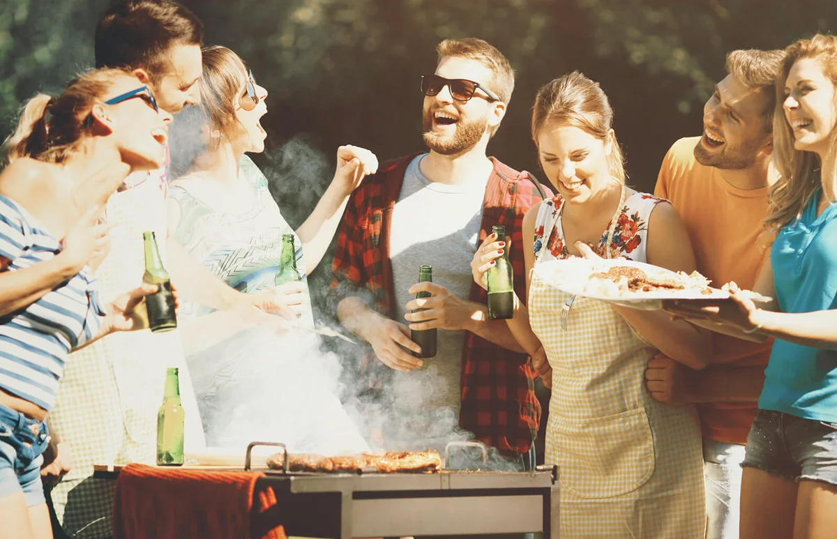 Friends having backyard barbecue party