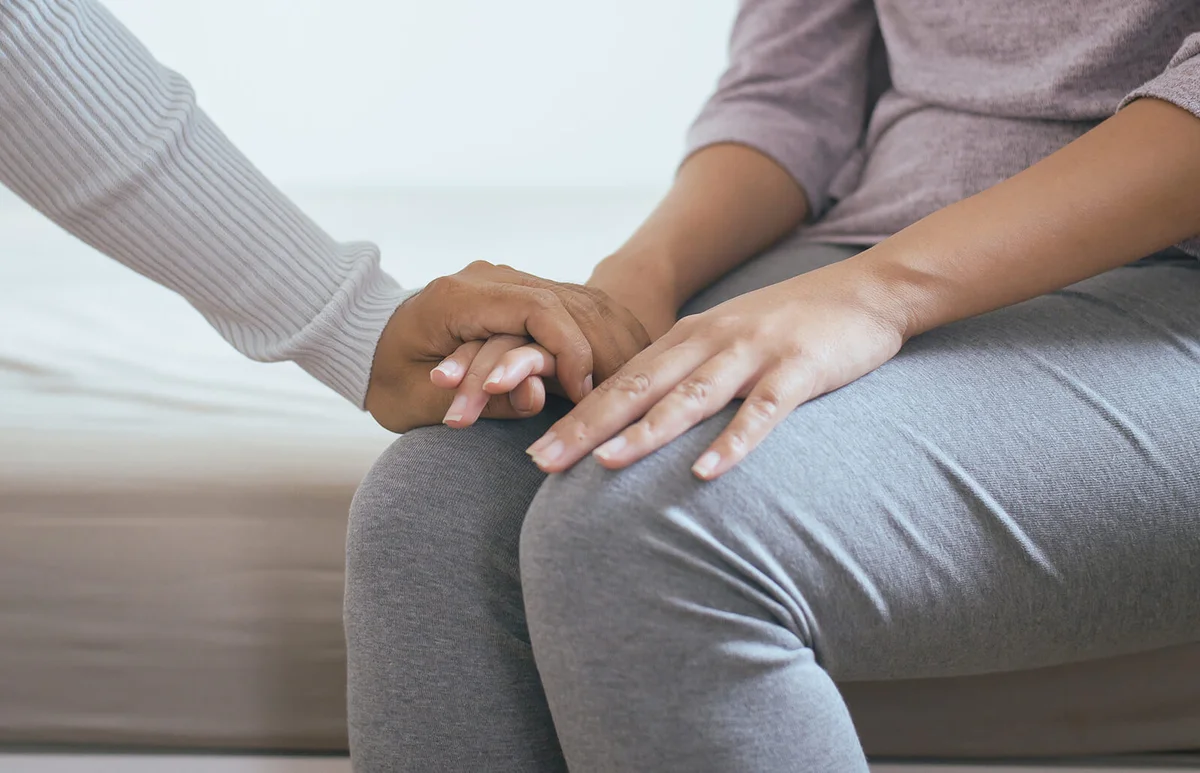 Man giving hand to depressed woman
