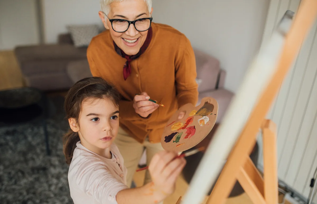Woman and granddaughter painting