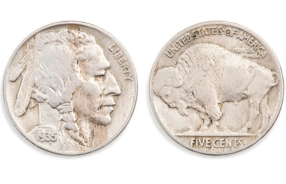 Antique five cents on white background