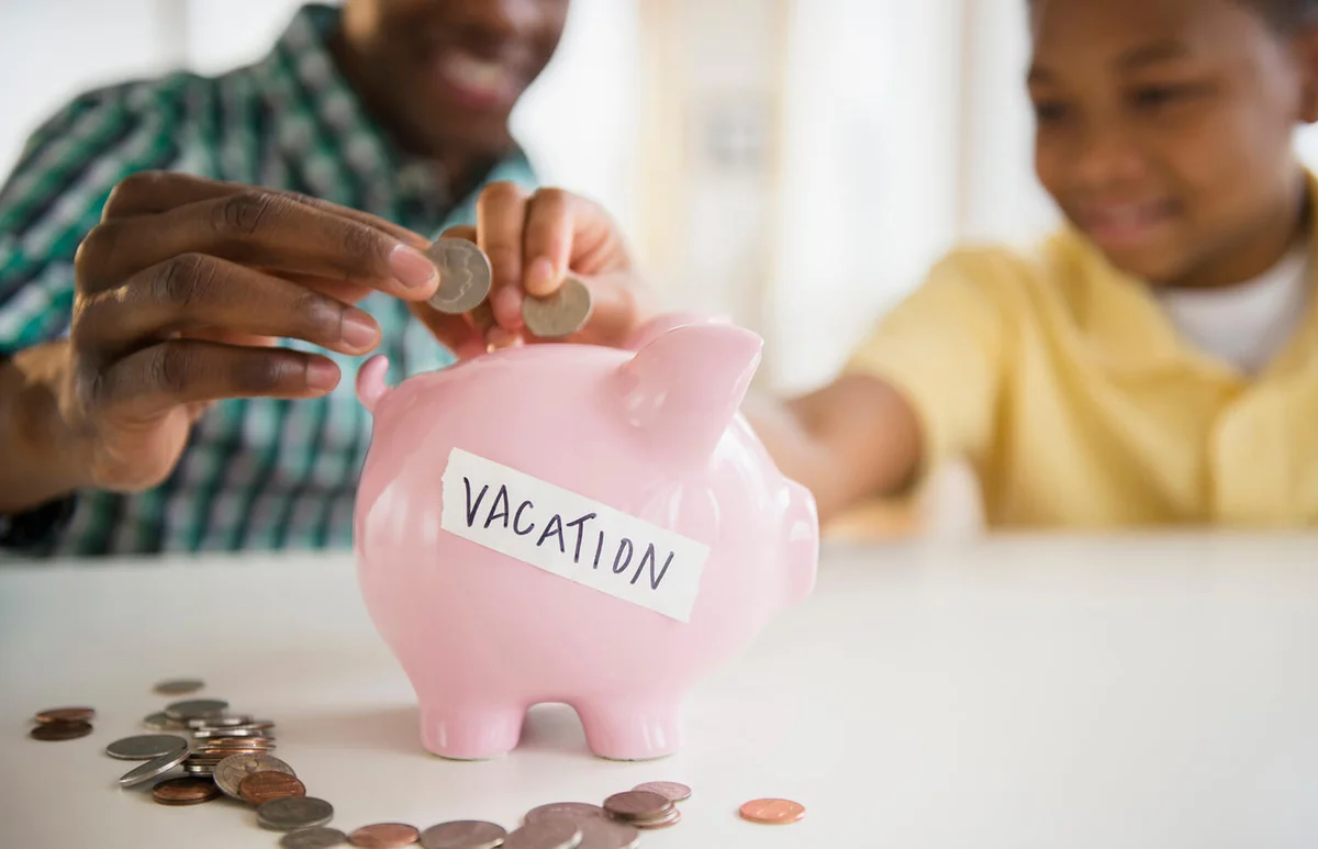 Father and son saving coins for vacation
