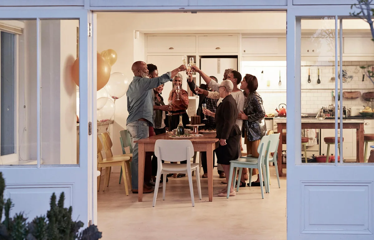 Family toasting drinks during birthday party