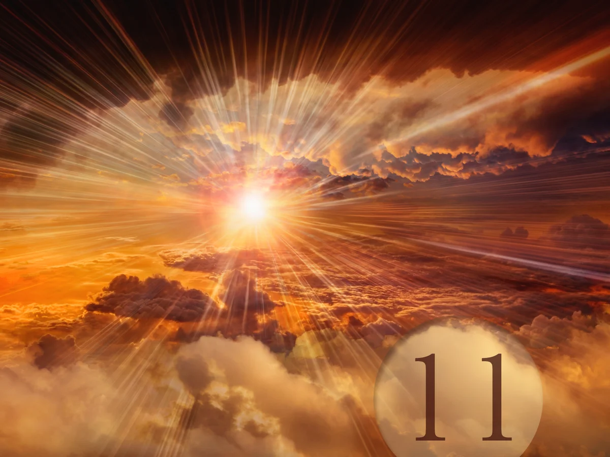 Sunbeams shining through clouds in dramatic sky and number 11