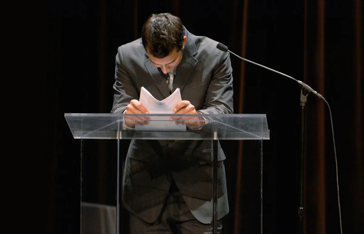 Businessman leaning on podium