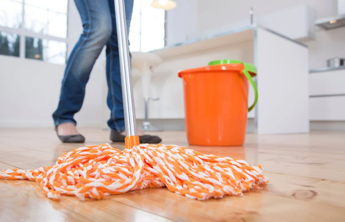 Woman mopping kitchen floor