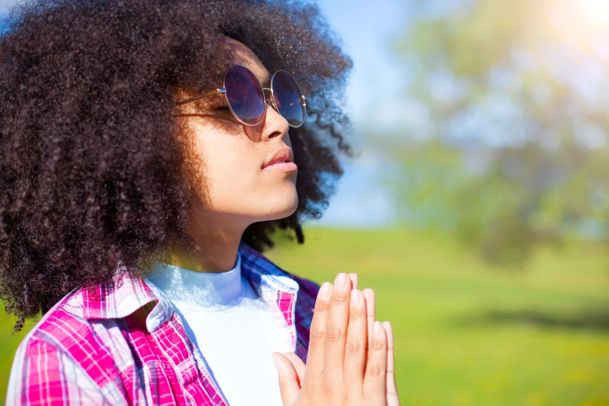 Woman feeling blessed outdoors