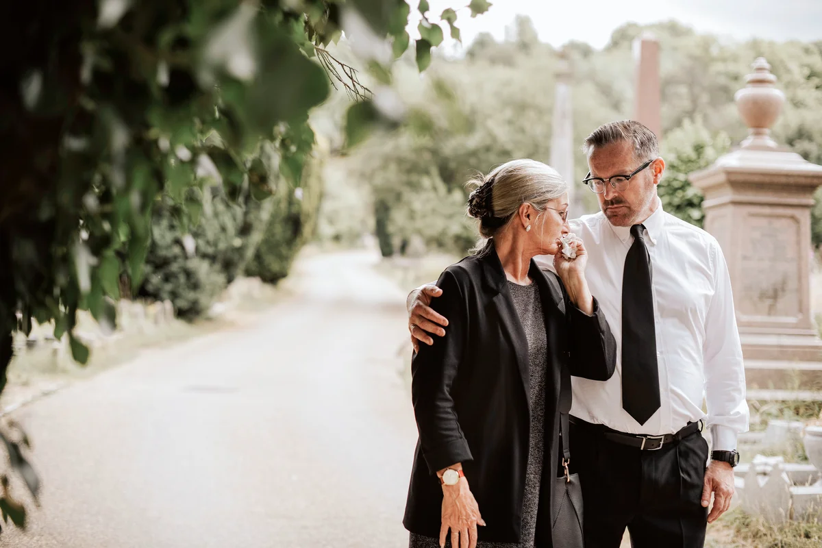 Husband trying to comfort his wife due to her loss