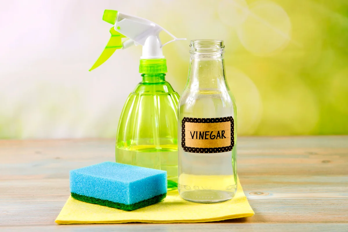 White vinegar in spray bottle to remove stains and smells