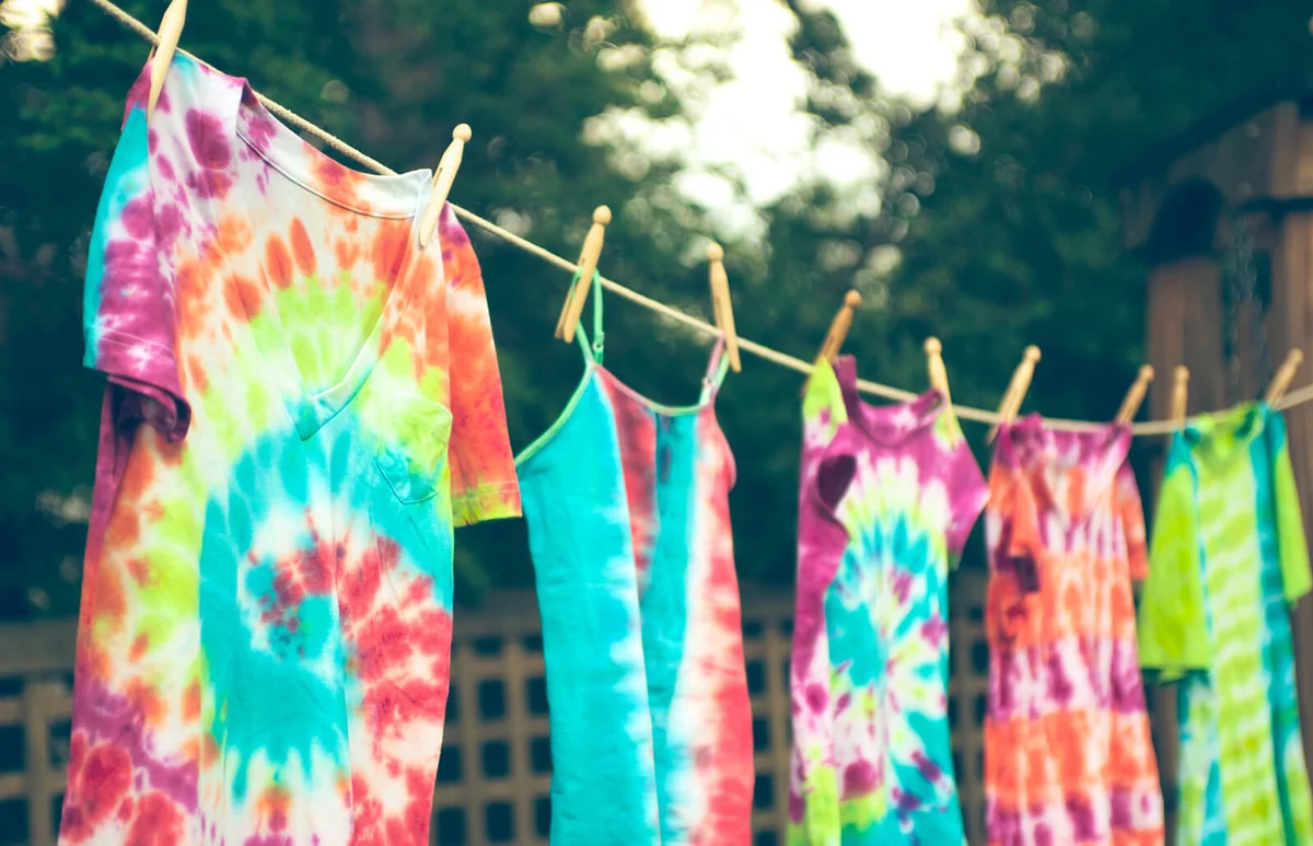 Tie dyed t-shirts hanging from a clothes line