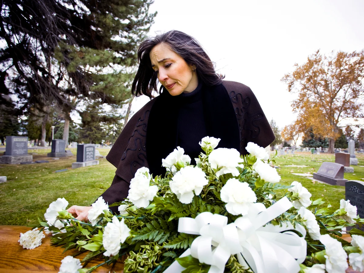 Woman at a funeral with flowers