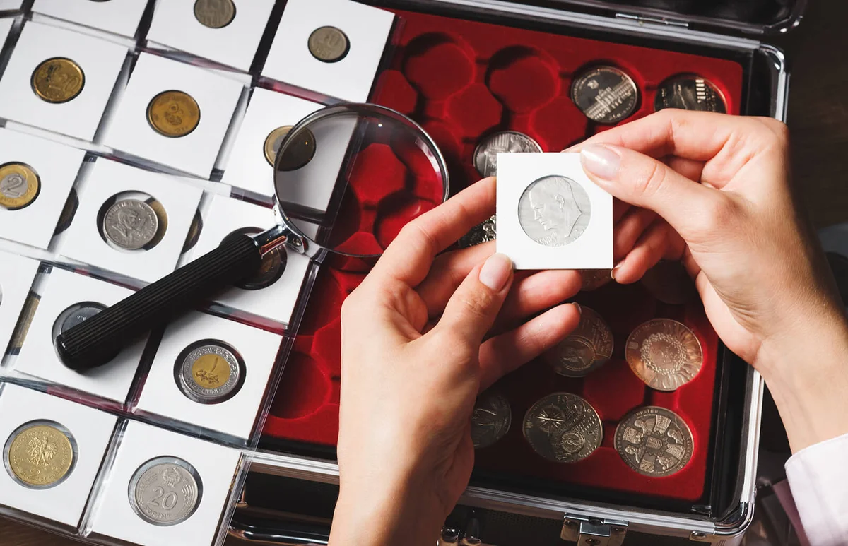 Box with collectible coins and magnifying glass