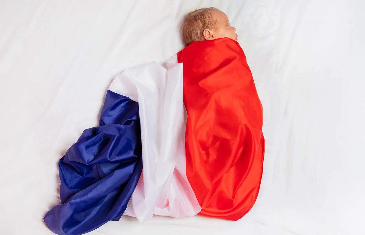 newborn baby wrapped in French flag