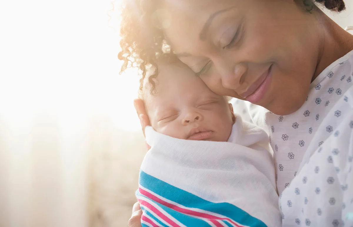mother cradling newborn baby