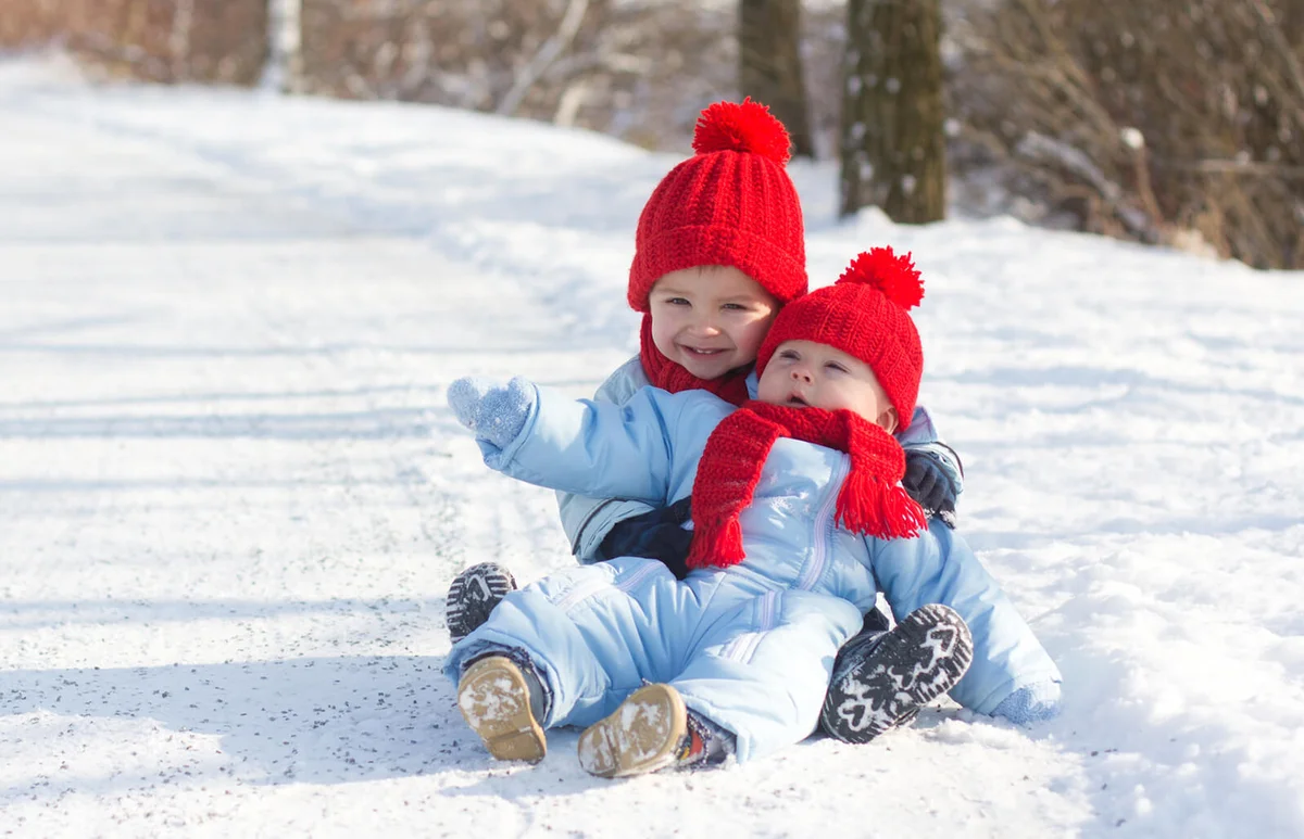 Two boys brothers with same hats